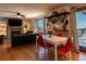 Open-concept living and dining area with hardwood floors, fireplace, and a sliding door with lovely mountain views at 783 Calgary Way, Golden, CO 80401