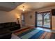 Finished living room with sliding glass doors, a leather sofa, and an area rug at 783 Calgary Way, Golden, CO 80401