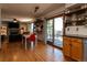 Open-concept living space with a dining area, fireplace, and deck access through sliding glass doors at 783 Calgary Way, Golden, CO 80401