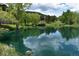 Scenic pond with a gazebo and trees, creating a tranquil and picturesque outdoor space for residents at 783 Calgary Way, Golden, CO 80401