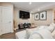 Finished basement with sectional sofa, large TV, and game storage at 147 Chapel Hill Cir, Brighton, CO 80601