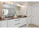 Double vanity bathroom with modern finishes and a large mirror at 147 Chapel Hill Cir, Brighton, CO 80601