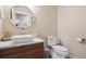 Modern bathroom with a white sink, wood vanity, and large mirror at 147 Chapel Hill Cir, Brighton, CO 80601