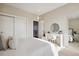 Well-lit bedroom with a queen bed, vanity, and mirrored closet doors at 147 Chapel Hill Cir, Brighton, CO 80601