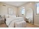 Bright bedroom with a queen bed and large arched window at 147 Chapel Hill Cir, Brighton, CO 80601