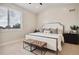 King bedroom with large window and two ottomans at 147 Chapel Hill Cir, Brighton, CO 80601