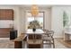 Kitchen dining area with wooden table and access to backyard at 147 Chapel Hill Cir, Brighton, CO 80601