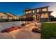 Two-story home with three-car garage, stone accents, and landscaped walkway at 147 Chapel Hill Cir, Brighton, CO 80601
