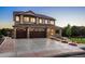 Two-story home with a three-car garage and stone exterior at 147 Chapel Hill Cir, Brighton, CO 80601