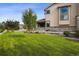 Landscaped front yard with lush lawn and mature trees at 147 Chapel Hill Cir, Brighton, CO 80601
