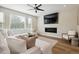 Living room with fireplace, sectional sofa, and hardwood floors at 147 Chapel Hill Cir, Brighton, CO 80601
