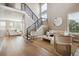 Bright living room with hardwood floors, modern furniture, and high ceilings at 147 Chapel Hill Cir, Brighton, CO 80601