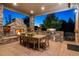 Covered patio with fireplace, built-in grill, and dining area at 147 Chapel Hill Cir, Brighton, CO 80601