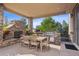 Covered patio features a stone fireplace and outdoor dining area at 147 Chapel Hill Cir, Brighton, CO 80601
