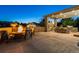 Night view of the backyard patio with firepit and dining area at 147 Chapel Hill Cir, Brighton, CO 80601