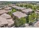 An expansive neighborhood featuring tan homes with tile roofs, lush green spaces, and mature trees at 7160 S Wenatchee Way # F, Aurora, CO 80016