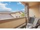 Balcony view with chairs, stone pillar, and building in the background at 7160 S Wenatchee Way # F, Aurora, CO 80016
