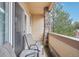 Balcony featuring chairs, small table, and a stone pillar, and an outdoor view at 7160 S Wenatchee Way # F, Aurora, CO 80016