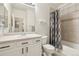 Well-lit bathroom featuring a vanity with white cabinets and a shower with a patterned curtain at 7160 S Wenatchee Way # F, Aurora, CO 80016