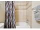 Close up view of a tiled shower and bathtub, with shower curtain and towel rack at 7160 S Wenatchee Way # F, Aurora, CO 80016