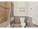 Bathroom featuring toilet, towel rack, tub with curtain, and tiled wall at 7160 S Wenatchee Way # F, Aurora, CO 80016