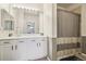 Bathroom featuring a large mirror, white vanity and shower with neutral tiled walls and a curtain at 7160 S Wenatchee Way # F, Aurora, CO 80016
