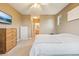 A cozy carpeted bedroom with a ceiling fan and ensuite bathroom entrance, plus a TV at 7160 S Wenatchee Way # F, Aurora, CO 80016