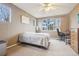 Bedroom featuring a window with views of the surrounding neighborhood, along with a workspace and a ceiling fan at 7160 S Wenatchee Way # F, Aurora, CO 80016