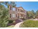 Charming multi-level condo featuring a stone facade, private balconies, and lush landscaping at 7160 S Wenatchee Way # F, Aurora, CO 80016