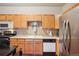 Functional kitchen with updated appliances, generous counter space, and wood cabinetry at 7160 S Wenatchee Way # F, Aurora, CO 80016