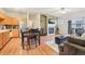 Open concept living area with a modern kitchen, hardwood floors, a fireplace, and balcony access at 7160 S Wenatchee Way # F, Aurora, CO 80016