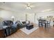 Inviting living area with a plush sofa, cozy recliner, hardwood floors, and an adjacent modern kitchen at 7160 S Wenatchee Way # F, Aurora, CO 80016