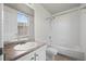 Bright bathroom features a tub, white vanity and updated fixtures with a large window at 12816 Ironstone Way # 203, Parker, CO 80134