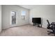 A bright bedroom with neutral carpet features a window and a door to the outside at 12816 Ironstone Way # 203, Parker, CO 80134