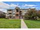A beautiful exterior view of the building with a well-manicured lawn and blue skies above at 12816 Ironstone Way # 203, Parker, CO 80134