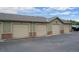 Garages with beige doors and green siding offer convenient parking for residents at 12816 Ironstone Way # 203, Parker, CO 80134