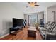 This living room has hardwood floors, ample seating, and lots of natural light at 12816 Ironstone Way # 203, Parker, CO 80134