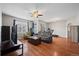 The inviting living room has gleaming hardwood floors and a ceiling fan at 12816 Ironstone Way # 203, Parker, CO 80134