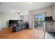 The home's open concept living room has deck access and sleek hardwood floors at 12816 Ironstone Way # 203, Parker, CO 80134