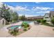Inviting community pool and jacuzzi are surrounded by lounge chairs and green space at 12816 Ironstone Way # 203, Parker, CO 80134