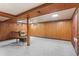 Spacious basement with wood paneling, carpet, and recessed lighting at 8521 E Cornell Dr, Denver, CO 80231