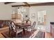 Bright dining room showcasing a chandelier and hardwood flooring, adjacent to the staircase at 8521 E Cornell Dr, Denver, CO 80231