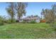 Expansive grassy backyard with mature trees and a covered patio at 6260 W 45Th Pl, Wheat Ridge, CO 80033
