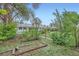 Lush backyard featuring raised garden beds, grass, and mature trees at 6260 W 45Th Pl, Wheat Ridge, CO 80033