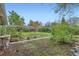 Spacious backyard with a stone pathway, greenery, and mature trees at 6260 W 45Th Pl, Wheat Ridge, CO 80033