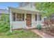 Charming home with a cozy front porch, secure screen door, and a well-maintained walkway leading to the entrance at 6260 W 45Th Pl, Wheat Ridge, CO 80033