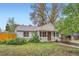 Well-kept home featuring a neat lawn, mature trees, and tidy landscaping, enhancing its curb appeal at 6260 W 45Th Pl, Wheat Ridge, CO 80033