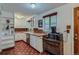 Charming kitchen with white cabinets, brick backsplash, and updated appliances at 6260 W 45Th Pl, Wheat Ridge, CO 80033