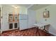 Quaint kitchen featuring ample cabinet storage, a classic white refrigerator, and a checkered tile floor at 6260 W 45Th Pl, Wheat Ridge, CO 80033