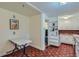 The kitchen nook has additional shelving, a vintage table and unique flooring at 6260 W 45Th Pl, Wheat Ridge, CO 80033